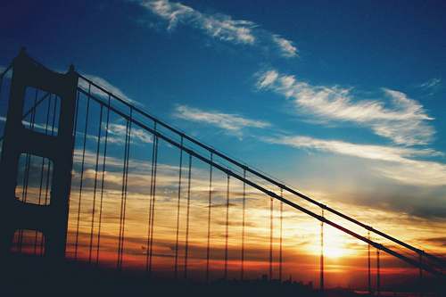 sky silhouette photo of bridge sunrise